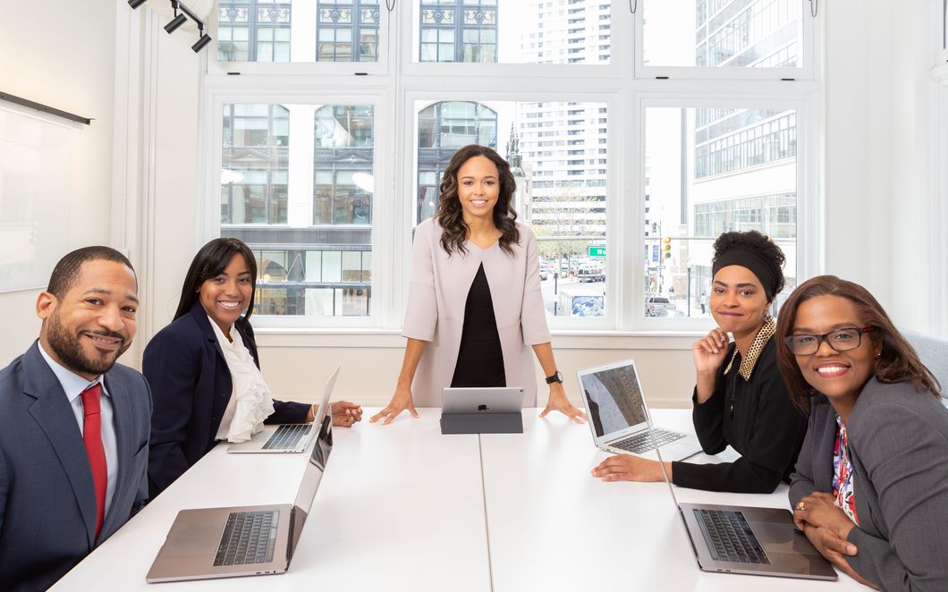 A management team meeting around a boardroom table